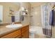 Well-lit bathroom featuring a sink, toilet, and shower-tub combo at 7809 Bandit Dr, Castle Rock, CO 80108