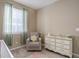 Bedroom featuring a cozy armchair, dresser, and large window with natural light at 7809 Bandit Dr, Castle Rock, CO 80108