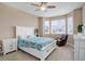 Inviting bedroom with a white bed frame, ceiling fan, and natural light from the windows at 7809 Bandit Dr, Castle Rock, CO 80108