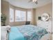 Cozy bedroom with neutral walls, ceiling fan, and natural light pouring through the windows at 7809 Bandit Dr, Castle Rock, CO 80108