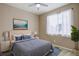 Serene bedroom with a large window, ceiling fan, and cozy decor accents for relaxation at 7809 Bandit Dr, Castle Rock, CO 80108