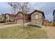 Charming two-story home with stone accents, manicured lawn, and attached garage at 7809 Bandit Dr, Castle Rock, CO 80108