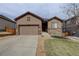 Attractive single-Gathering home featuring a well-maintained lawn, stone accents, and a spacious driveway at 7809 Bandit Dr, Castle Rock, CO 80108