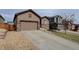 Inviting home featuring a two-car garage, complemented by stone landscaping at 7809 Bandit Dr, Castle Rock, CO 80108
