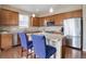 Bright kitchen boasts stainless steel appliances, granite countertops, and an island with barstool seating at 7809 Bandit Dr, Castle Rock, CO 80108