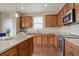 Well-equipped kitchen featuring stainless steel appliances, granite countertops, and hardwood floors at 7809 Bandit Dr, Castle Rock, CO 80108
