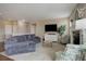 Bright living room featuring a gray sectional sofa, fireplace, and ample natural light at 7809 Bandit Dr, Castle Rock, CO 80108