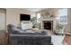 Inviting living room with a stone fireplace, large windows, and modern decor at 7809 Bandit Dr, Castle Rock, CO 80108