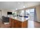 Open-concept living space featuring a kitchen island, fireplace, and sliding glass doors to the outside at 7809 Bandit Dr, Castle Rock, CO 80108