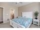 Neutral main bedroom featuring a white bed frame, neutral carpet, and en suite bathroom at 7809 Bandit Dr, Castle Rock, CO 80108