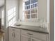 Elegant bar area with countertop, cabinets, and natural light at 2755 Geneva St, Denver, CO 80238