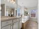 Bright primary bath with dual vanities, soaking tub, and large windows at 2755 Geneva St, Denver, CO 80238