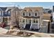 View of the charming home with a welcoming porch and a driveway leading to a detached garage at 2755 Geneva St, Denver, CO 80238