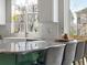 Bright kitchen featuring a large window, white cabinets, and a stylish gray countertop island with seating at 2755 Geneva St, Denver, CO 80238