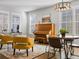 Inviting living room with large windows, a piano, stylish seating, and a round table at 2755 Geneva St, Denver, CO 80238