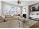 Cozy living room featuring a fireplace, comfortable seating, and bright windows at 2755 Geneva St, Denver, CO 80238