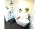Modern bathroom featuring walk-in shower, soaking tub, black fixtures, and stylish tile at 2831 Shadow Lake Rd, Lafayette, CO 80026