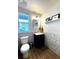 Cozy half bathroom featuring stylish tilework, modern fixtures, and a wooden floor at 2831 Shadow Lake Rd, Lafayette, CO 80026