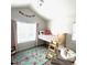 Cozy bedroom with unique bed design, complemented by a colorful rug and ample natural light at 2831 Shadow Lake Rd, Lafayette, CO 80026