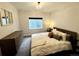 Bedroom featuring a large dresser, a queen-size bed, a mirror and basement windows at 2831 Shadow Lake Rd, Lafayette, CO 80026