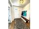 Inviting entryway featuring a bench, coat rack, and a patterned rug on wood flooring at 2831 Shadow Lake Rd, Lafayette, CO 80026