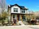 Charming two-story home with solar panels, white siding, a covered porch, and landscaped front yard at 2831 Shadow Lake Rd, Lafayette, CO 80026