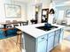Modern kitchen island with a cooktop and breakfast bar, seamlessly connected to the dining area at 2831 Shadow Lake Rd, Lafayette, CO 80026