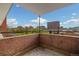 Private brick balcony offering a stunning city skyline view at 1196 N Grant St # 501, Denver, CO 80203