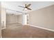 Spacious bedroom features mirrored closet doors, neutral carpeting and a ceiling fan at 1196 N Grant St # 501, Denver, CO 80203