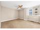 Bright bedroom with a ceiling fan, neutral carpet and an adjacent window for natural lighting at 1196 N Grant St # 501, Denver, CO 80203