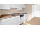 Functional kitchen featuring white cabinetry, stainless steel sink, and essential appliances at 1196 N Grant St # 501, Denver, CO 80203