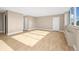 Open living room with a closet door, light wood floors, and natural light at 1196 N Grant St # 501, Denver, CO 80203