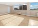 Open living room area with hardwood floors and large windows offering natural light at 1196 N Grant St # 501, Denver, CO 80203