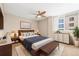 Comfortable primary bedroom with a ceiling fan, a dresser, and an adjacent window at 1196 N Grant St # 501, Denver, CO 80203