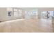 Bright living room with large windows, light wood floors, and access to the porch area at 7293 Waterleaf Trl, Littleton, CO 80125