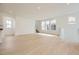 Spacious living room features recessed lighting, many windows, and light wood floors at 7293 Waterleaf Trl, Littleton, CO 80125