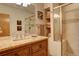 Primary bathroom boasts a glass shower and a granite topped wood vanity at 2122 Montane Dr, Golden, CO 80401