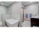 Modern bathroom with a soaking tub, glass-enclosed shower, and sleek vanity at 2122 Montane Dr, Golden, CO 80401