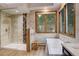 Modern bathroom features a walk-in shower, soaking tub, and large window with wooded views at 2122 Montane Dr, Golden, CO 80401