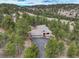 Beautiful home nestled in a wooded area with a large driveway and a charming tiled roof at 2122 Montane Dr, Golden, CO 80401