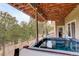Outdoor hot tub with a wood ceiling and a view of the surrounding trees at 2122 Montane Dr, Golden, CO 80401
