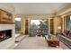 Bright living room with a stone fireplace, built-in shelves, and a large window with scenic views at 2122 Montane Dr, Golden, CO 80401