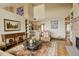 Open living room featuring hardwood floors, a fireplace, and views of the kitchen area at 2122 Montane Dr, Golden, CO 80401