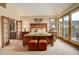 Spacious main bedroom with balcony access, a large bed, and an ensuite bathroom at 2122 Montane Dr, Golden, CO 80401