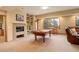A spacious recreation room with a fireplace, pool table, and comfortable seating at 2122 Montane Dr, Golden, CO 80401