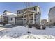 Two-story house with gray siding, stone accents, and a snow-covered front yard at 5332 Blue Lunar Ln, Castle Rock, CO 80104