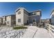 Gray two-story home with a backyard and snowy lawn at 5332 Blue Lunar Ln, Castle Rock, CO 80104