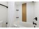 Clean bathroom featuring a bathtub with a shower curtain, tiled walls, and modern fixtures at 955 Eudora St # 1606, Denver, CO 80220