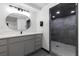 A stylish bathroom includes a modern vanity with quartz countertops and a sleek tiled shower stall at 955 Eudora St # 1606, Denver, CO 80220