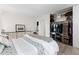 Bright bedroom featuring a patterned bedspread, light wood floors, and an organized closet with sliding doors at 955 Eudora St # 1606, Denver, CO 80220